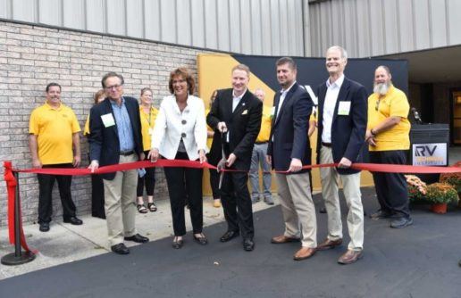 A photograph of about 12 people at a ribbon cutting ceremony for RVTI