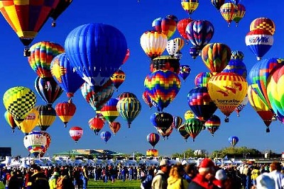 A picture of hot air balloons filling the blue sky at the Albuquerque Balloon Festival in New Mexico.