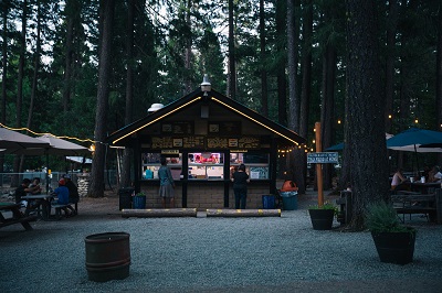 A picture of the interior of a KOA campground with a food stand and tents around