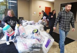 A picture of Dutchmen RV employees helping gather supplies for a Sleep in Heavenly Peace partnership event.