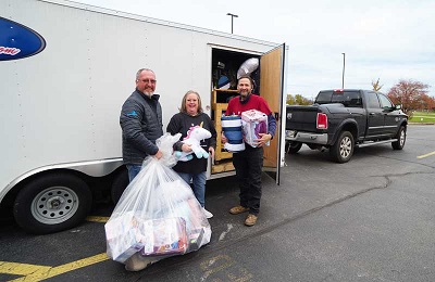 A picture of Dutchmen RV employees helping gather supplies for a Sleep in Heavenly Peace partnership event.