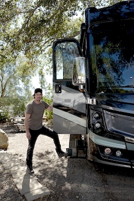 Ian Somerhalder poses next to his new Discovery LXE 40M Fleetwood RV.