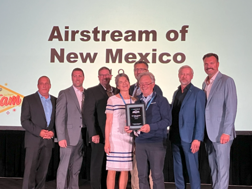 A picture of the Airstream of New Mexico team receiving Airstream's top dealer in service award at the manufacturer's 2024 dealer meeting.