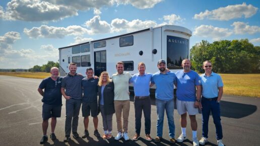 A picture of the Alliance RV team outside the Benchmark destination trailer.