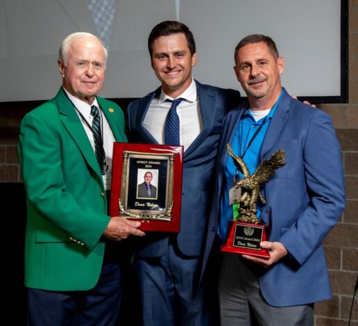 A picture of Dana Nelsen (R) the 2024 Spirit Award winner. RV/MH Hall of Fame President Darryl Searer (L) and Executive Vice President Ryan Szklarek (M) presented the award.