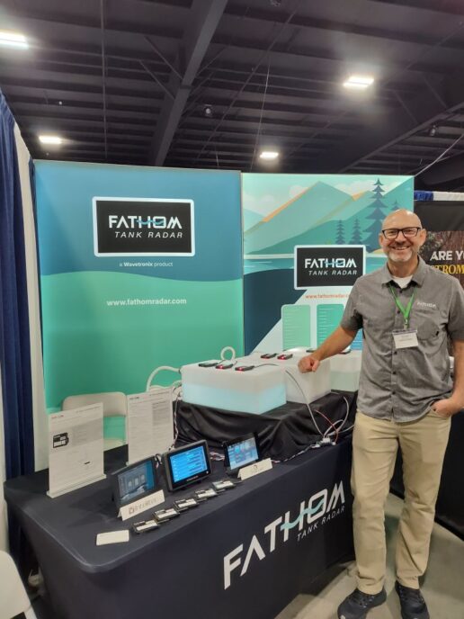 A picture of Fathom Research Engineer Thomas Karlinsey next to the Fathom Tank Radar display.