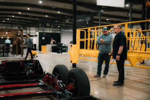 A picture of RV Composition Expo attendees examine chassis.