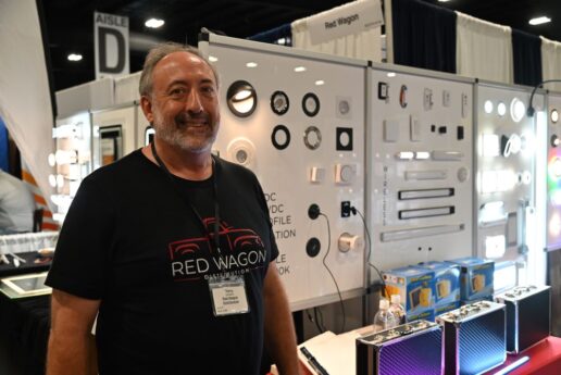 A picture of Terry Goddard, Red Wagon OEM field representative, next to the supplier's display of lights at the RV/MH Hall of Fame Supplier's Show.