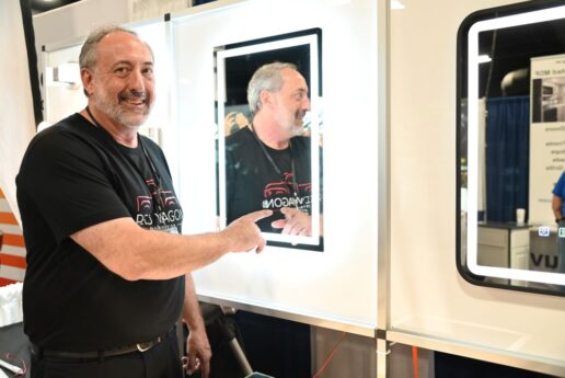 A picture of Terry Goddard, Red Wagon OEM field representative, displaying the supplier's lighted mirror.