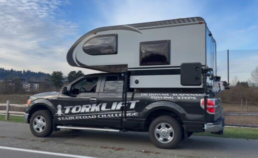 A picture of a truck camper on a Torklift-branded truck.