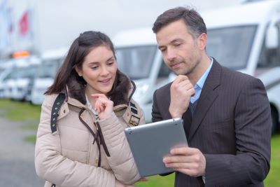 A picture of two people looking at information on a tablet