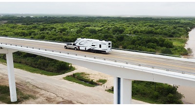 A picture of the 2023 Grand Design Solitude on the road