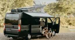 A picture of a family sitting at the door opening of a Jayco Type B motorhome.