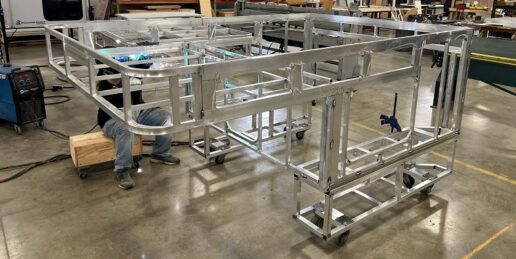 A picture of the OV-X aluminum truck topper camper structure being welded by a Soaring Eagle employee