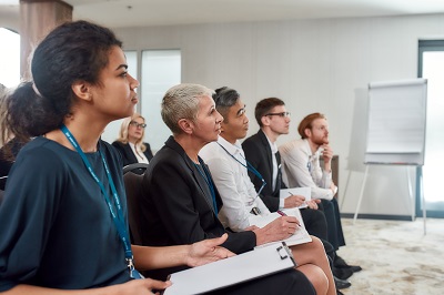 A picture of a group of diverse learners paying attention in a classroom