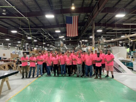 A picture of Aliner's employees wearing pink shirts to show their support of breast cancer awareness month in October 2023.