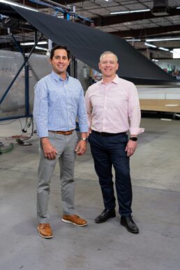 A picture of (L to R) Carefree of Colorado's Kevin Mayer, vice president of sales and marketing, and Eric Cannon, president, in front of a company's awning at its Colorado plant.