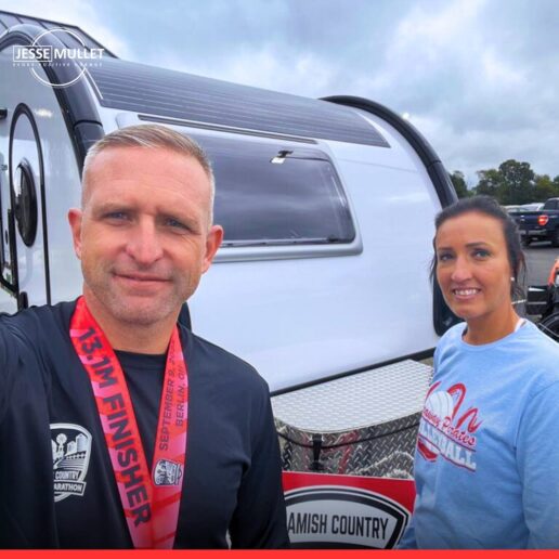 A picture of nuCamp owner Jesse Mullet and his wife, Karen, standing in front of a nuCamp teardrop.