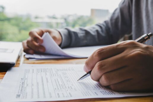 A picture of a man filling out documents.