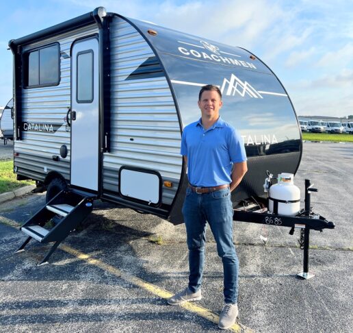 A picture of Coachmen Catalina General Manager Mike Gaeddert in front of a Catalina towable..
