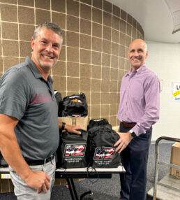 (L to R) KZ President Ryan Juday and Vice President and General Counsel Colin Reilly review backpacks donated to area elementary schools.