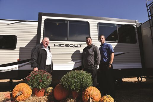 In a 2018 image, Thor Industries Chairman Emeritus Peter Orthwein, then-Keystone RV CEO Matt Zimmerman and then-Keystone RV President Jeff Runels are pictured with a Hideout travel trailer.