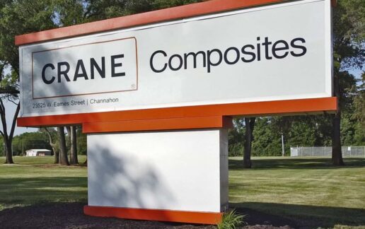 A picture of a Crane Composites sign with their logo.